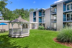 East Haven apartment for rent - A gazebo is in the middle of a grassy area in front of a building.