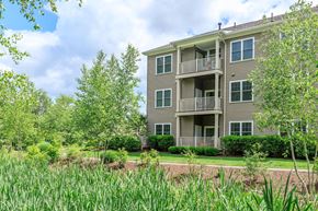 New London apartment for rent - A two-story building with a balcony on the second floor.