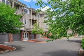 Simsbury apartment for rent - A large apartment complex with a driveway and trees.