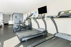 Waterbury apartment for rent - A treadmill and a stationary bike are in a gym.