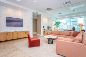 Stamford apartment for rent - A living room with a red chair and a pink couch.
