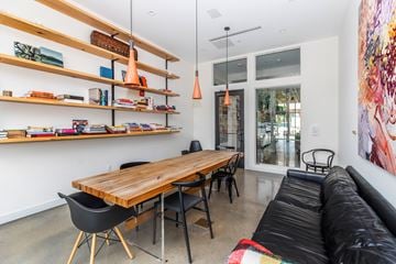 Bloomfield apartment for rent - A modern living room with a wooden table and black chairs.