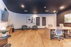 Norwalk apartment for rent - A modern office space with wooden floors and furniture.