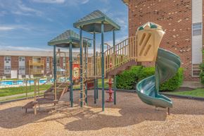 Naugatuck apartment for rent - A playground with a green slide and a red fire hydrant.