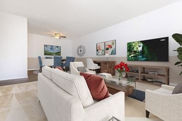 Groton apartment for rent - A living room with a white couch and a television on the wall.