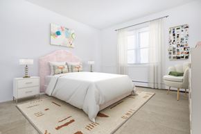 Groton apartment for rent - A bedroom with a large bed and a pink headboard.