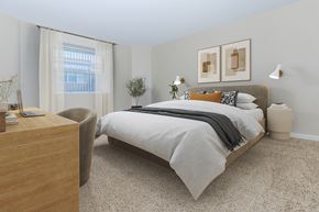 West Haven apartment for rent - A bedroom with a large bed and a chair.
