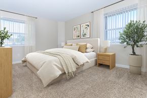 West Haven apartment for rent - A bedroom with a bed, nightstand, and a plant.