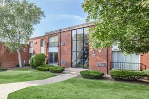 Rocky Hill apartment for rent - A brick building with a green lawn in front.