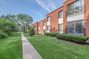 Rocky Hill apartment for rent - A long grassy pathway leads to a brick building.