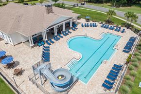 Yulee apartment for rent - A large outdoor pool with a slide and sun loungers.