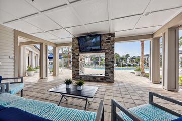 Jacksonville apartment for rent - A living room with a television and a pool in the background.
