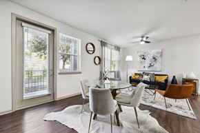 Jacksonville apartment for rent - A modern dining room with a glass table and chairs.