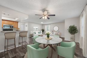 Orlando apartment for rent - A dining room with a white table and green chairs.