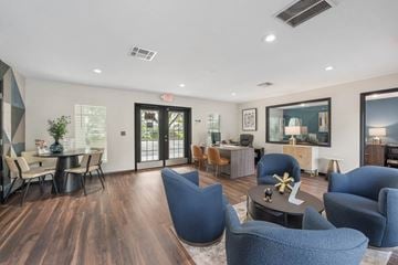 Orlando apartment for rent - A living room with blue chairs and a wooden floor.