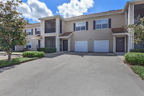 Dade City apartment for rent - a house with a garage and a driveway in front of it
