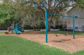 Dade City apartment for rent - a playground with a swing set and monkey bars