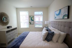 Cliffwood apartment for rent - A bedroom with a large bed and a mirror on the wall.