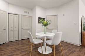 Bloomfield apartment for rent - A dining room with a white table and chairs.