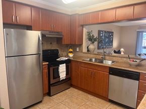 Bradenton apartment for rent - A kitchen with a stainless steel refrigerator and a black oven.