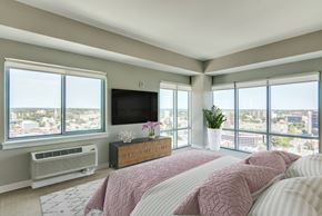 Stamford apartment for rent - A bedroom with a large bed and a flat screen TV.