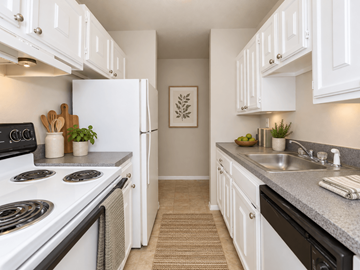 Naugatuck apartment for rent - A kitchen with white cabinets and a stove top oven.