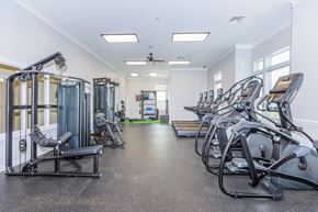 Manchester apartment for rent - A gym with a variety of equipment including treadmills, weight machines, and a rowing machine.