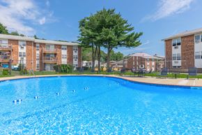 Naugatuck apartment for rent - A swimming pool in front of apartment buildings.