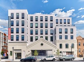 New Jersey apartment for rent - the facade of a building with cars parked in front of it