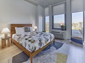 Jersey City apartment for rent - a bedroom with a bed and a window with a city view