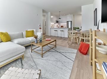 New Jersey apartment for rent - A modern living room with a white sofa and a grey rug.