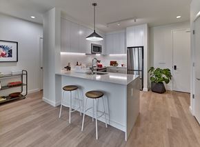 New Jersey apartment for rent - a kitchen with a large island with three stools