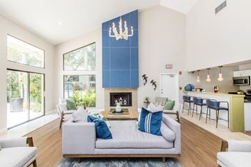 Bradenton apartment for rent - A living room with a grey couch and a blue pillow.