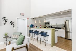 Bradenton apartment for rent - A kitchen with a white counter and a white chair.