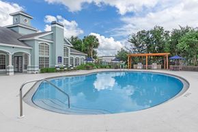 Jacksonville apartment for rent - A large swimming pool in front of a building with a gazebo.