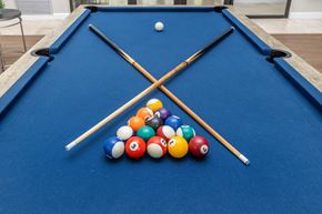 Bradenton apartment for rent - A pool table with a cue stick crossed over it and balls lined up on the side.