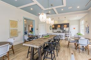 Yulee apartment for rent - A dining room with a long wooden table surrounded by chairs.