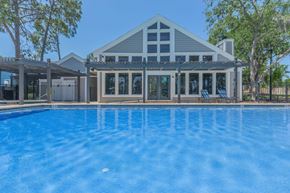 Apopka apartment for rent - A house with a pool in front of it.