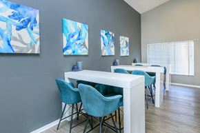 Spring Hill apartment for rent - A dining room with a white table and blue chairs.