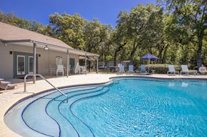 Brooksville apartment for rent - A swimming pool with a slide and a house in the background.