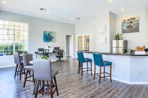 Panama City apartment for rent - A modern kitchen with blue chairs and a wooden floor.