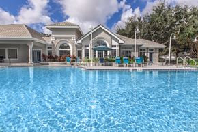 Jacksonville apartment for rent - A large swimming pool in front of a building.