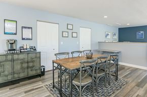 Bradenton apartment for rent - A dining room with a wooden table and chairs.