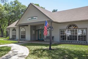 Brooksville apartment for rent - A small building with a sign that says "Kinship" on it.
