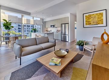 Jersey City apartment for rent - A modern living room with a large sofa and a coffee table.