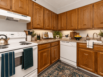 Middletown apartment for rent - A kitchen with wooden cabinets and white appliances.