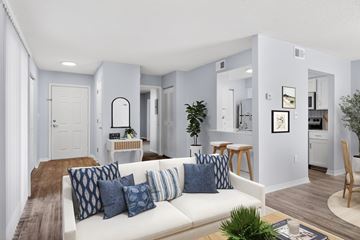 Richmond Hill apartment for rent - A living room with a white couch and blue pillows.