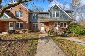 Meriden townhouse for rent - A house with a grey roof and a brick facade.