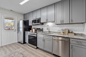 Wake Forest apartment for rent - A kitchen with a refrigerator, oven, and microwave at West Oak Apartments, North Carolina 27587