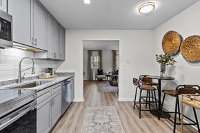 Wake Forest apartment for rent - A kitchen with a dining table and chairs at West Oak Apartments, Wake Forest, NC 27587